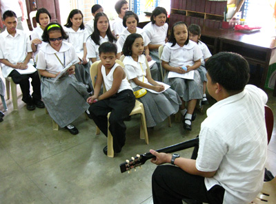 Blind disciplemaker with guitar and group